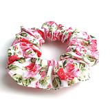 rose hair scrunchie laying on a white background