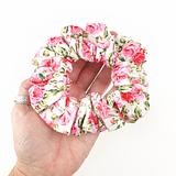 rose hair scrunchie laying on a ladies outstretched palm