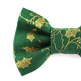left front side of green Christmas dog bow tie with gold holly leaves on a white background