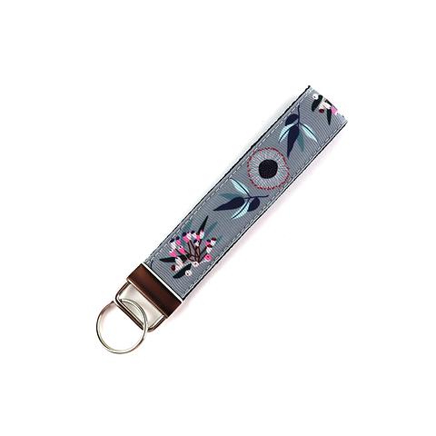 grey wristlet key ring featuring gum leaves and gumnuts on white background